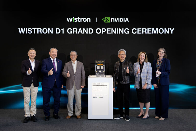 Six people standing and giving thumbs up at Wistron D1 Grand Opening with NVIDIA chip display_ (1).png